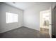 A bedroom boasting carpet floors and great light with an adjacent laundry room at 6029 Allanche Ave, Las Vegas, NV 89141