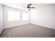 An empty bedroom with carpeted floors, a ceiling fan, and bright natural light at 6029 Allanche Ave, Las Vegas, NV 89141