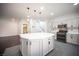 Bright, open kitchen with a large center island, stainless steel appliances, and stylish pendant lighting at 6029 Allanche Ave, Las Vegas, NV 89141