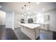 Modern kitchen with white cabinets, stainless appliances, and a large center island with pendant lights at 6029 Allanche Ave, Las Vegas, NV 89141