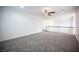 A loft area with neutral colored walls, carpet floors and a ceiling fan at 6029 Allanche Ave, Las Vegas, NV 89141