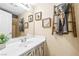 Well-lit bathroom with decorative mirror, vanity, towel ladder, and framed artwork at 6050 Golden Corral Trl # 102, Henderson, NV 89011