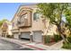 Inviting townhome featuring an attached garage, balcony, and well-maintained landscaping at 6050 Golden Corral Trl # 102, Henderson, NV 89011