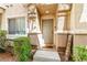 Charming front entrance with welcoming door, manicured bushes, and 'Welcome' sign at 6050 Golden Corral Trl # 102, Henderson, NV 89011