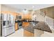 Kitchen featuring stainless steel appliances, granite counters, and tile flooring at 6050 Golden Corral Trl # 102, Henderson, NV 89011