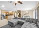 Spacious living room with comfortable sectional sofa, open layout, and staircase access at 6050 Golden Corral Trl # 102, Henderson, NV 89011