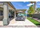 Spacious backyard features covered patio with dining area, lush lawn, and access to the sparkling pool at 6173 Sabine Ranch Rd, Las Vegas, NV 89131