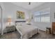 Comfortable bedroom features carpet floors, a large window, and is decorated with a queen size bed at 6173 Sabine Ranch Rd, Las Vegas, NV 89131