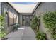 Inviting front courtyard with a seating area, lush greenery, and a shade awning at 6173 Sabine Ranch Rd, Las Vegas, NV 89131