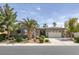 Charming single-story home featuring a landscaped front yard, mature palm trees, and a two-car garage at 6173 Sabine Ranch Rd, Las Vegas, NV 89131