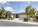 Beautiful single-story home with manicured landscaping, palm trees, and a driveway leading to an attached garage at 6173 Sabine Ranch Rd, Las Vegas, NV 89131