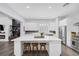 The bright kitchen features a large marble island, modern appliances, and ample storage at 6173 Sabine Ranch Rd, Las Vegas, NV 89131
