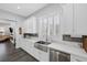 Modern kitchen with stainless steel appliances, marble countertops, and bright white cabinets at 6173 Sabine Ranch Rd, Las Vegas, NV 89131