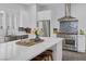 Bright kitchen features a marble countertop island, stainless steel appliances and blue backsplash at 6173 Sabine Ranch Rd, Las Vegas, NV 89131