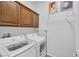 Bright laundry room with upper cabinets and modern LG washer and dryer at 6173 Sabine Ranch Rd, Las Vegas, NV 89131