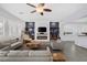 Open-concept living room featuring hardwood floors, a modern fireplace, and custom built-in shelving at 6173 Sabine Ranch Rd, Las Vegas, NV 89131