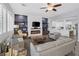 Bright and airy living room featuring a sleek fireplace, custom shelving, and comfortable seating at 6173 Sabine Ranch Rd, Las Vegas, NV 89131