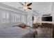 Comfortable bedroom includes a ceiling fan, recessed lights, plantation shutters, and a seating area at 6173 Sabine Ranch Rd, Las Vegas, NV 89131