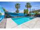 Sparkling pool with beach mural, palm trees, and inviting patio area perfect for relaxation and outdoor enjoyment at 6173 Sabine Ranch Rd, Las Vegas, NV 89131