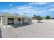 Spacious backyard with low maintenance gravel and covered patio, perfect for entertaining at 6204 Robin Hood Cir, Las Vegas, NV 89108