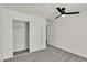 Modern bedroom with soft carpet, a ceiling fan, closet with sliding doors at 6204 Robin Hood Cir, Las Vegas, NV 89108