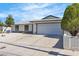 Single-story home with desert landscaping, concrete driveway, and an attached two-car garage at 6204 Robin Hood Cir, Las Vegas, NV 89108