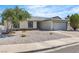 Well-maintained single-story home with desert landscaping, gray roof, and a two-car attached garage at 6204 Robin Hood Cir, Las Vegas, NV 89108