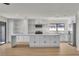 Bright, open kitchen with white cabinets, stainless steel appliances, and a large island with marble countertops at 6204 Robin Hood Cir, Las Vegas, NV 89108