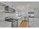 This stunning kitchen features stainless steel appliances and a stylish marble countertop island at 6204 Robin Hood Cir, Las Vegas, NV 89108