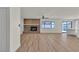 Spacious living room with hardwood floors, brick fireplace, and large windows offering ample natural light at 6204 Robin Hood Cir, Las Vegas, NV 89108