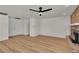 Bright living room with hardwood floors, brick fireplace, ceiling fan, and access to other rooms at 6204 Robin Hood Cir, Las Vegas, NV 89108