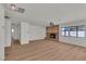 Bright living room with a brick fireplace and new flooring throughout at 6204 Robin Hood Cir, Las Vegas, NV 89108