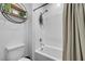 Clean bathroom design with a shower-tub combo with white tile, toilet, and shelving at 6318 Amber Sunrise St, North Las Vegas, NV 89031