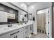 Bathroom features a double sink vanity with black hardware and a large framed mirror at 6318 Amber Sunrise St, North Las Vegas, NV 89031