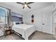 Bright bedroom with a ceiling fan, a decorative painting, and a cozy bed with white linens at 6318 Amber Sunrise St, North Las Vegas, NV 89031