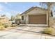 Well-maintained single-story home with desert landscaping, a spacious driveway, and a neutral color palette at 6318 Amber Sunrise St, North Las Vegas, NV 89031