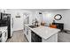 Bright kitchen features an island with white cabinets and granite countertops, plus stainless steel appliances at 6318 Amber Sunrise St, North Las Vegas, NV 89031