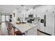 Bright, open kitchen with white cabinetry, granite countertops, stainless steel appliances, and a pantry at 6318 Amber Sunrise St, North Las Vegas, NV 89031