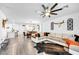 Open concept living space featuring modern decor, a spacious sectional, and seamless flow to the dining area at 6318 Amber Sunrise St, North Las Vegas, NV 89031