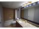 Bathroom with granite countertop, vanity, tile floor, framed mirror, shower and bath combo at 634 Oakmont Ave # 1903, Las Vegas, NV 89109