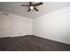 Spacious bedroom featuring dark laminate flooring, a ceiling fan, and a double-door closet at 634 Oakmont Ave # 1903, Las Vegas, NV 89109