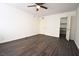 Bedroom featuring dark laminate flooring, a ceiling fan, closet, and neutral paint at 634 Oakmont Ave # 1903, Las Vegas, NV 89109