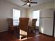 Cozy dining area features wood floors, wicker chairs, and natural light from the window at 634 Oakmont Ave # 1903, Las Vegas, NV 89109