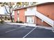 Two-story brick apartment building featuring designated parking and staircase access to the second floor entrance at 634 Oakmont Ave # 1903, Las Vegas, NV 89109