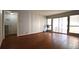 Bright living room with hardwood floors, neutral paint, sliding glass doors, and modern ceiling fan at 634 Oakmont Ave # 1903, Las Vegas, NV 89109