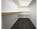 Spacious walk-in closet featuring wood laminate flooring, white walls, shelving, and hanging rods at 634 Oakmont Ave # 1903, Las Vegas, NV 89109