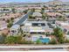 Aerial view of property showcasing a backyard oasis with pool, hot tub, solar panels, and covered patio at 7504 Frittata Ave, Las Vegas, NV 89113