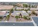 Beautiful aerial view of desert home with mature landscaping, tile roof, circular driveway, attached garage, and desert landscaping at 7504 Frittata Ave, Las Vegas, NV 89113