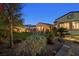 Backyard at twilight with lush turf and desert landscaping at 7504 Frittata Ave, Las Vegas, NV 89113