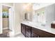 Modern bathroom featuring double sinks with dark cabinetry, and glass shower at 7504 Frittata Ave, Las Vegas, NV 89113